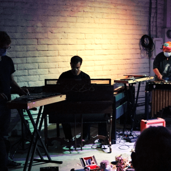 the three members of placeholder at coaxial. From left to right: Eric Lennartson on Bells, Daniel Newman-Lessler on Melodeon, M A Harms on Vibraphone