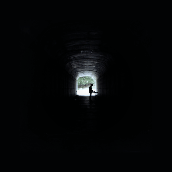 sillouhette of a man in a dark tunnel